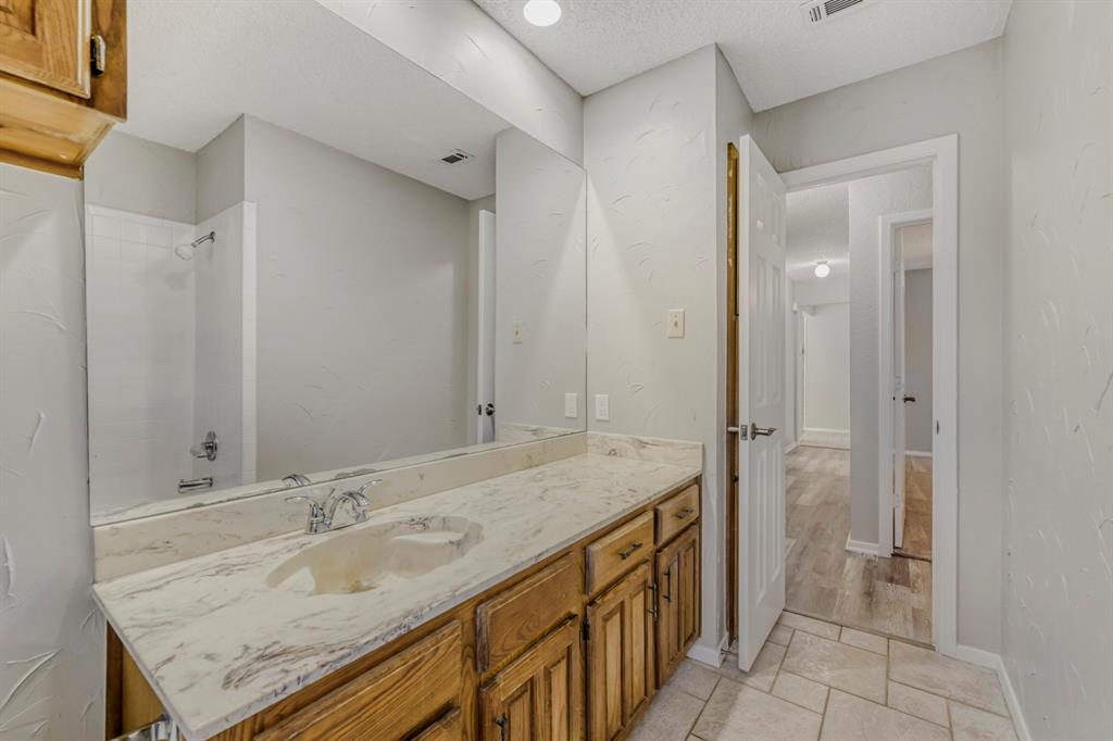 517 Kings Gate Road Willow Park, TX 76087 - Photo 18 of 28 a bathroom with a granite countertop sink and a mirror