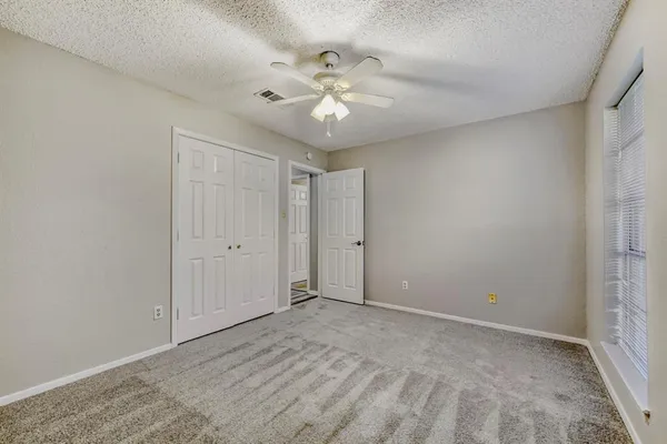 a view of small space with wooden floor and a window