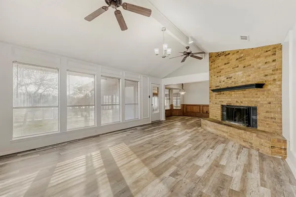 a view of empty room with fireplace and fan