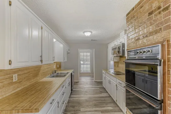 a large kitchen with a stove and a sink