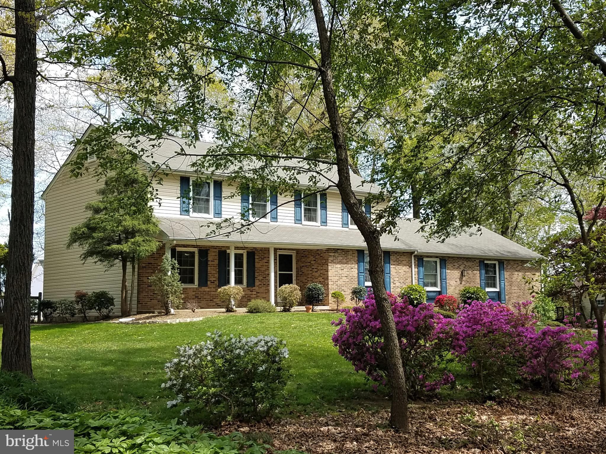 8137 Murphy Road Fulton, MD 20759 - Photo 1 of 56 a front view of a house with a garden and trees