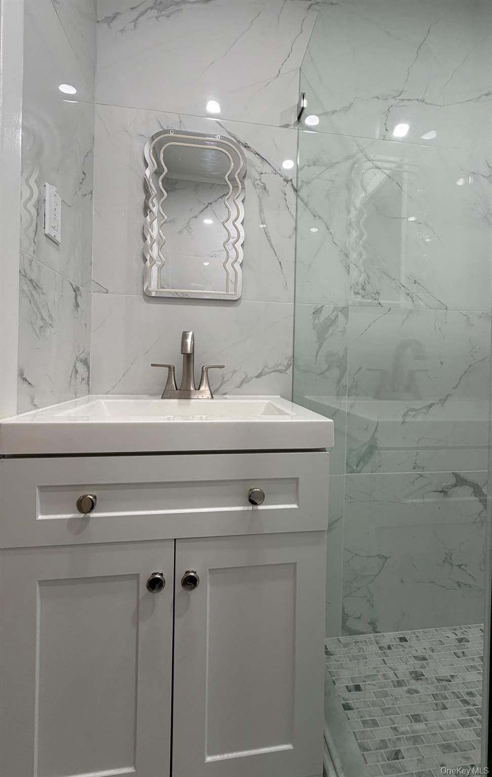 60 Medallion Road Kiamesha Lake, NY 12751 - Photo 24 of 44 a bathroom with a sink a vanity a mirror and shower