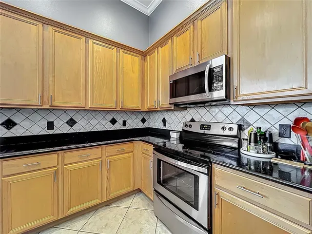 a walk in closet with lots of clothes and shoes