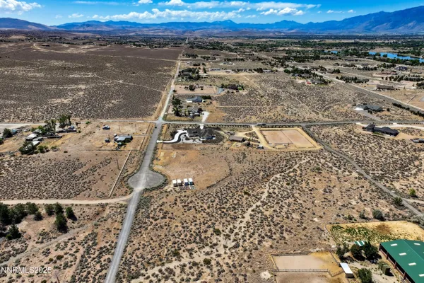 a view of a yard with wooden fence