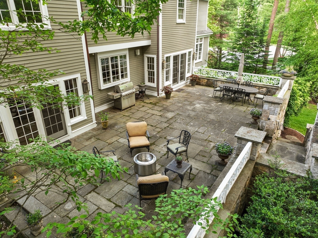 200 Edgewater Drive Needham, MA 02492 - Photo 15 of 41 a view of a patio with table and chairs potted plants and large tree