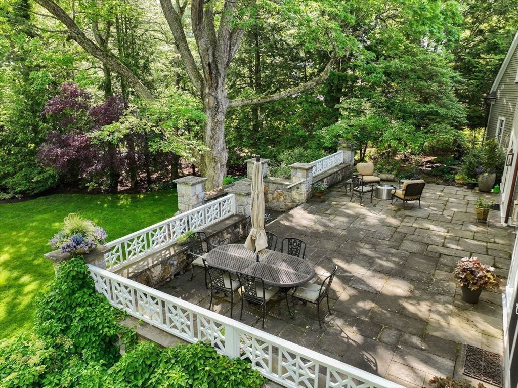 200 Edgewater Drive Needham, MA 02492 - Photo 16 of 41 a view of a chair and tables in the backyard