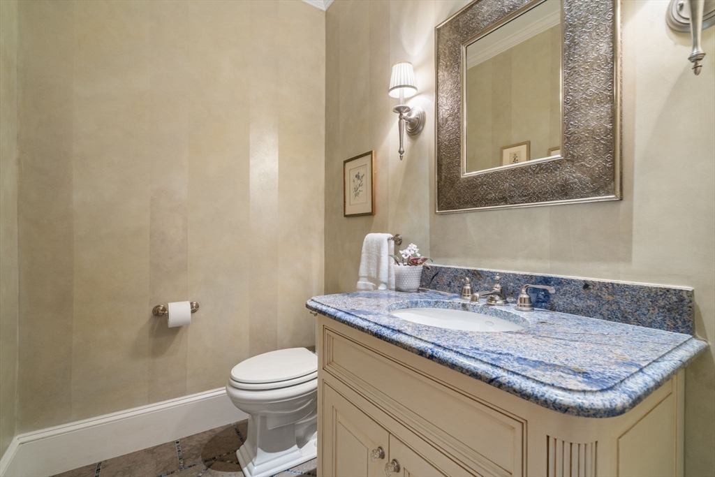 200 Edgewater Drive Needham, MA 02492 - Photo 19 of 41 a bathroom with a granite countertop sink a toilet and mirror
