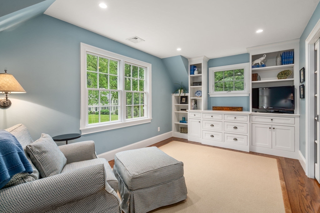 200 Edgewater Drive Needham, MA 02492 - Photo 23 of 41 a living room with furniture and a flat screen tv