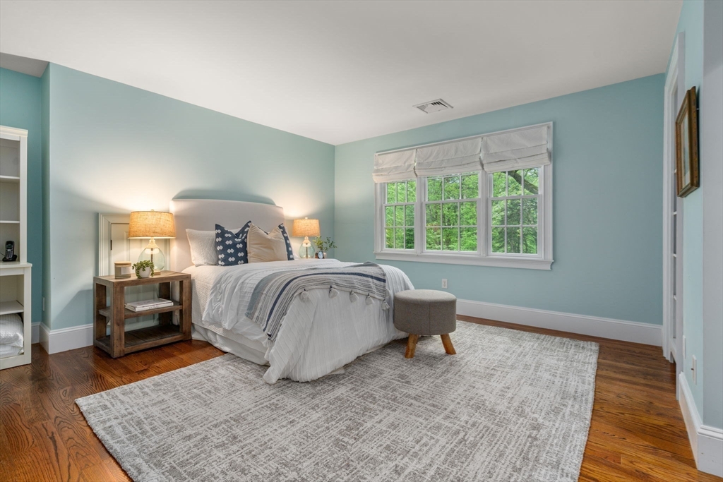 200 Edgewater Drive Needham, MA 02492 - Photo 25 of 41 a bedroom with a bed and wooden floor