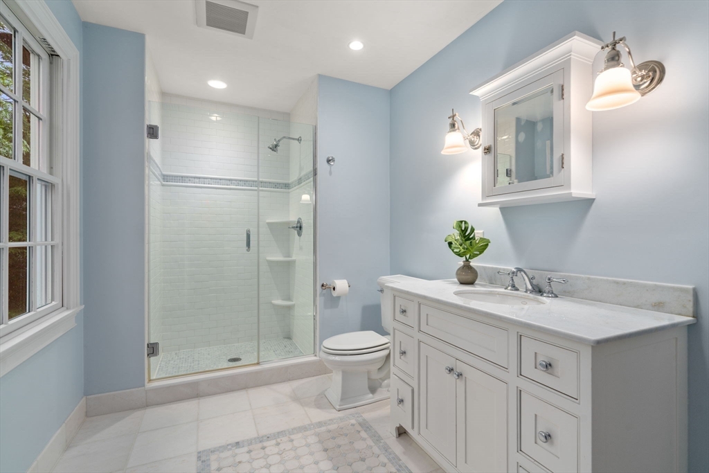 200 Edgewater Drive Needham, MA 02492 - Photo 26 of 41 a bathroom with a granite countertop sink a toilet and shower
