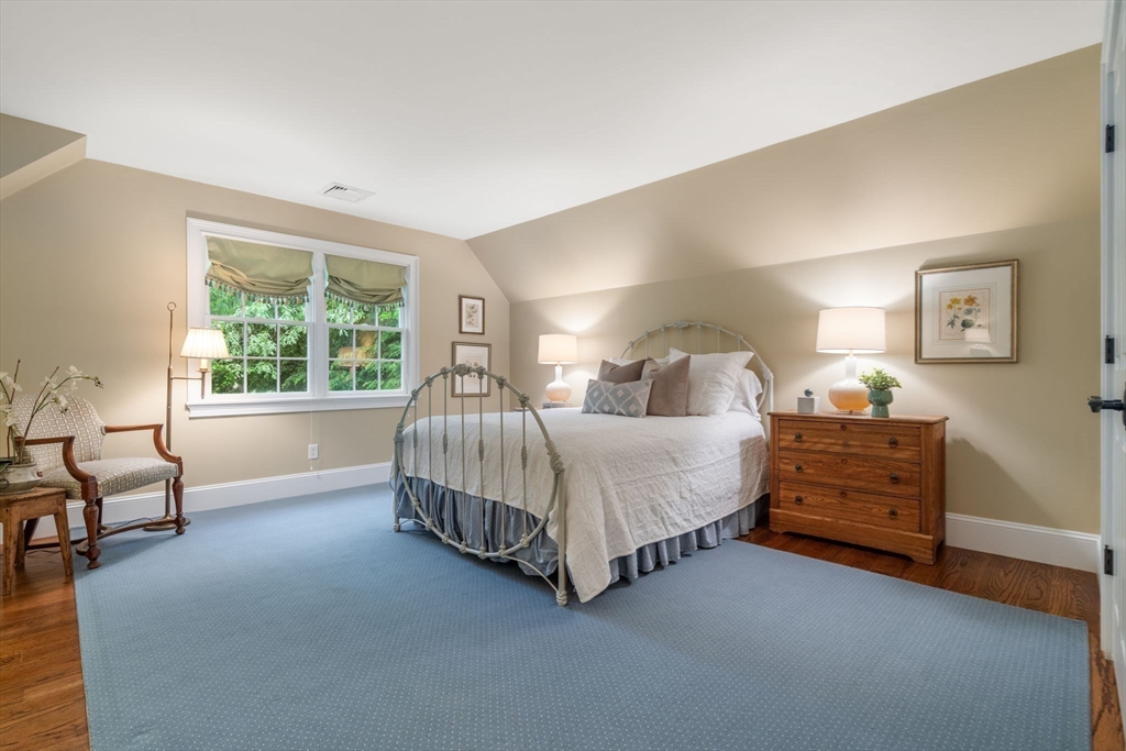200 Edgewater Drive Needham, MA 02492 - Photo 27 of 41 a bedroom with a bed and a dresser next to a window