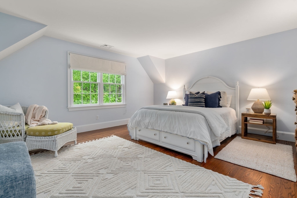 200 Edgewater Drive Needham, MA 02492 - Photo 28 of 41 a bedroom with a bed and a couch