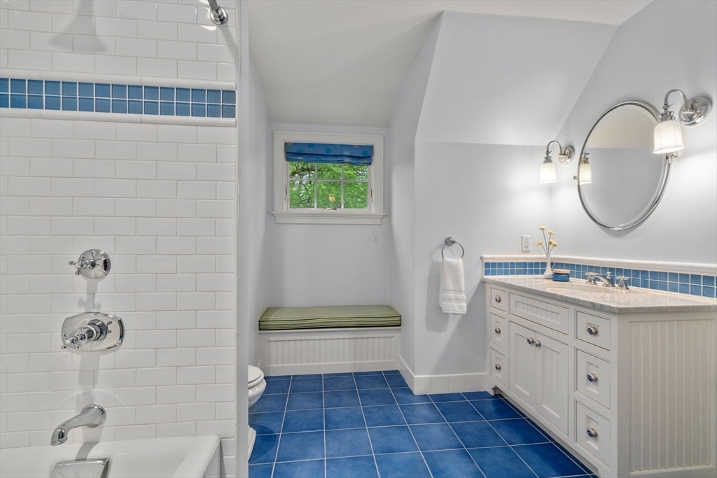 200 Edgewater Drive Needham, MA 02492 - Photo 29 of 41 a bathroom with a sink a toilet and a mirror