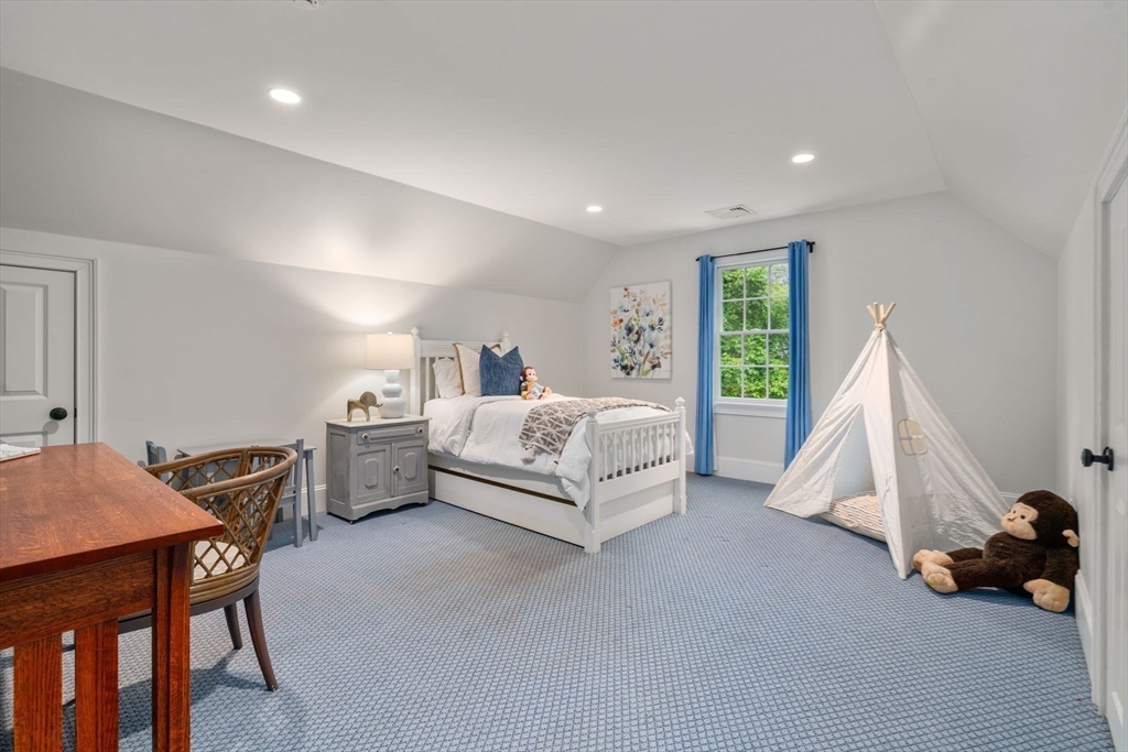 200 Edgewater Drive Needham, MA 02492 - Photo 30 of 41 a spacious bedroom with a bed and a table