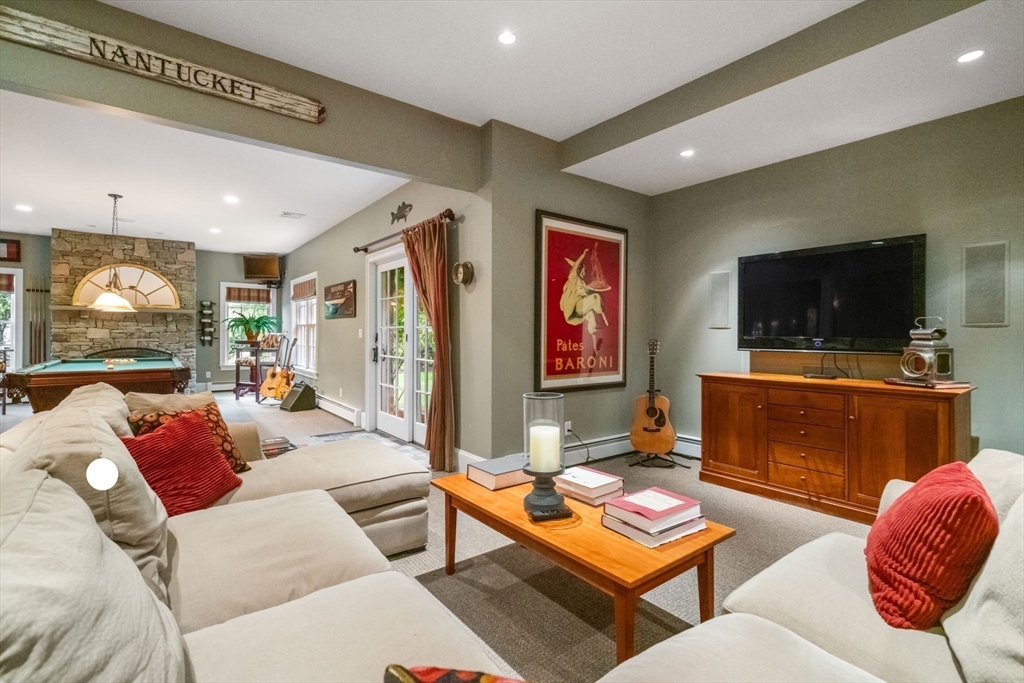 200 Edgewater Drive Needham, MA 02492 - Photo 32 of 41 a living room with furniture and a flat screen tv