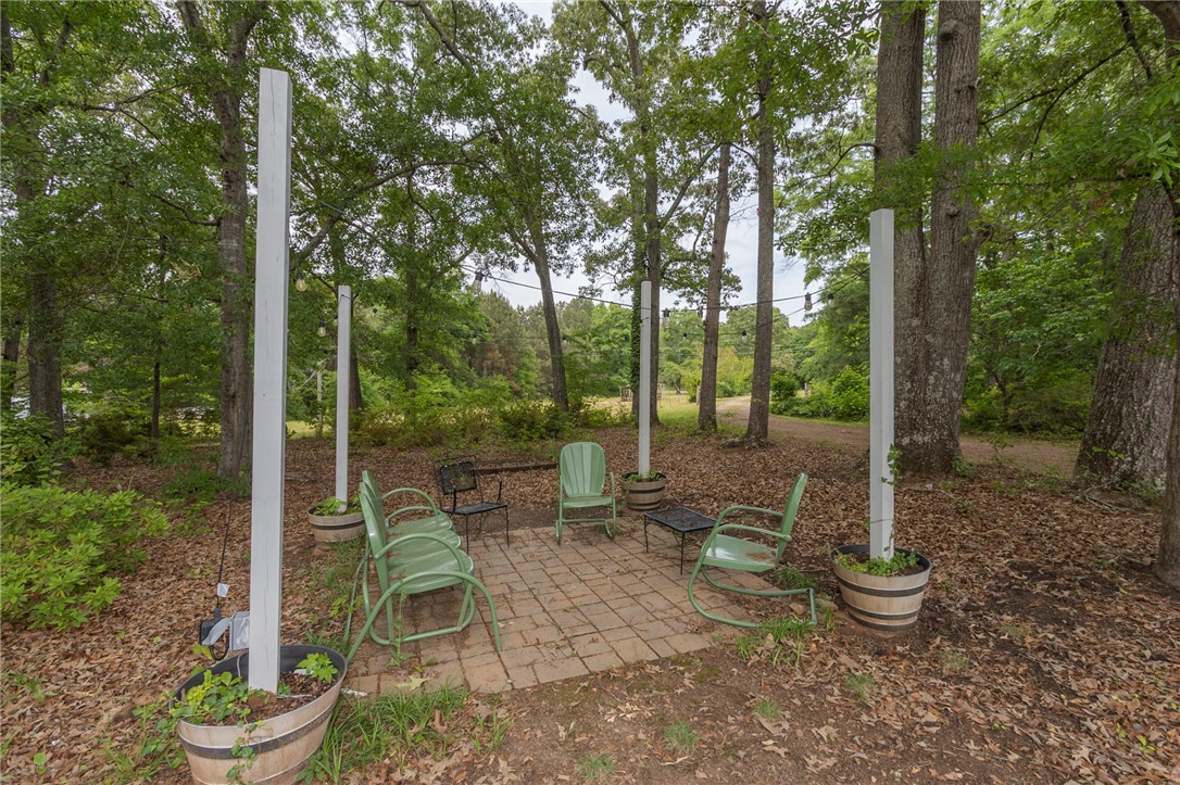 1116 Leatherdale Road Iva, SC 29655 - Photo 12 of 46 This tranquil outdoor retreat offers a charming patio, perfect for relaxation amidst nature.