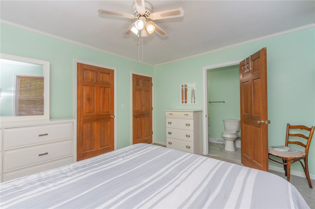 1116 Leatherdale Road Iva, SC 29655 - Photo 28 of 46 This spacious bedroom features a ceiling fan, crown molding, and direct access to a private bathroom.
