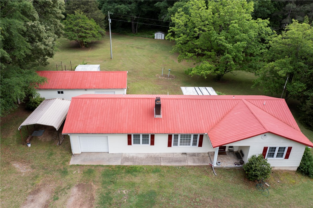 1116 Leatherdale Road Iva, SC 29655 - Photo 32 of 46 This charming residence features a striking red roof, a convenient attached garage, and ample outdoor space.