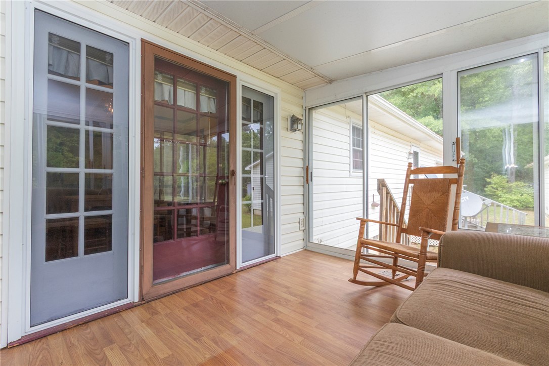 1116 Leatherdale Road Iva, SC 29655 - Photo 4 of 46 This bright sunroom offers a perfect indoor-outdoor living experience with ample natural light.