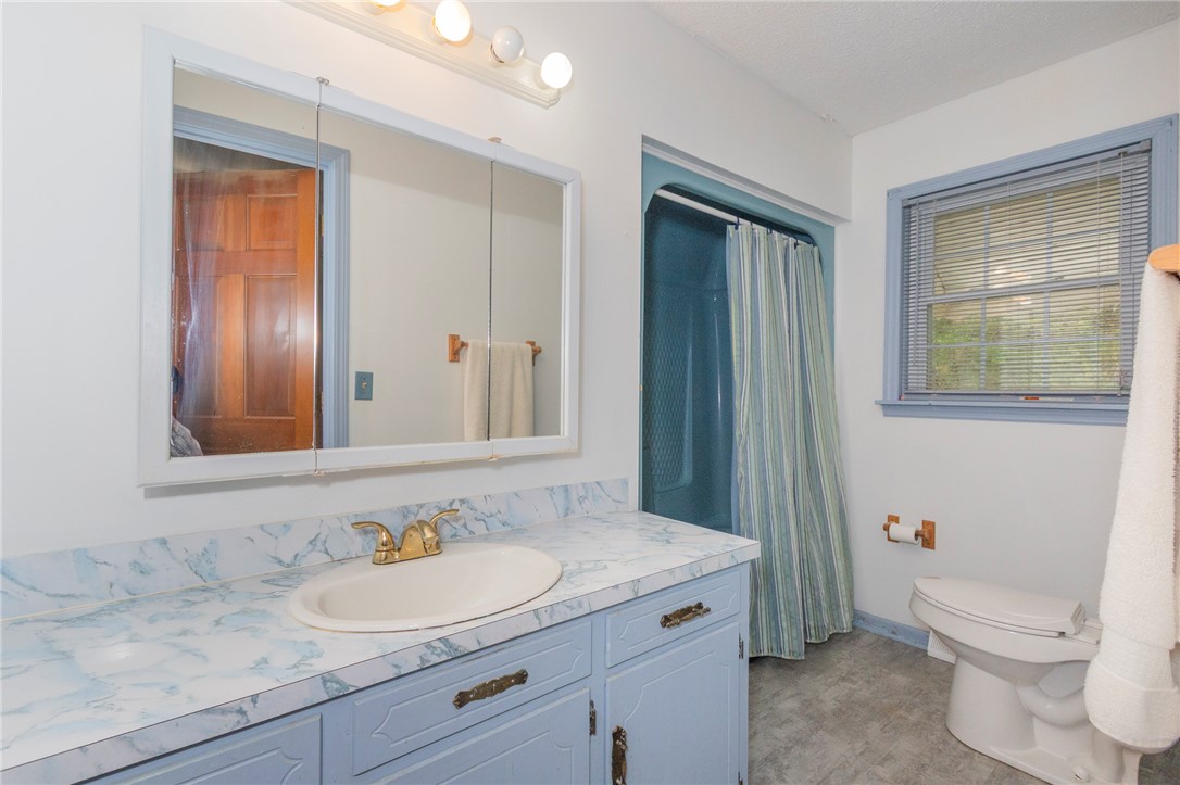 1116 Leatherdale Road Iva, SC 29655 - Photo 8 of 46 This bathroom features practical design with a shower, toilet, and vanity sink.