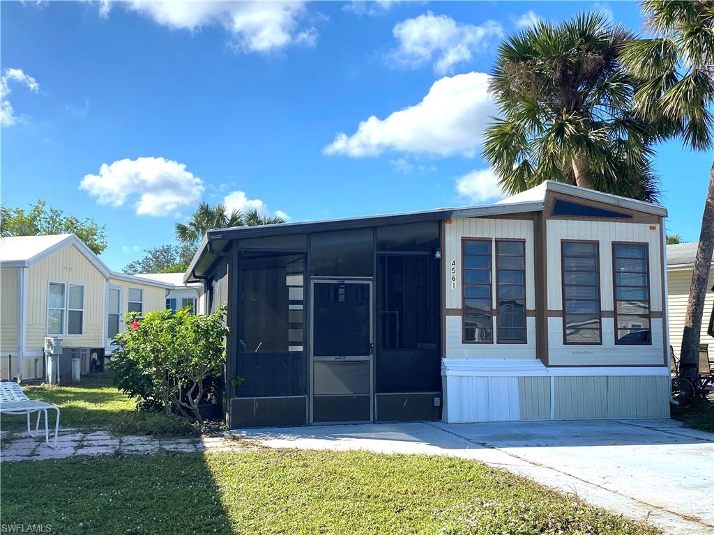 4561 Split Log Lane East Estero, FL 33928 - Photo 1 of 8 a front view of a house with a yard