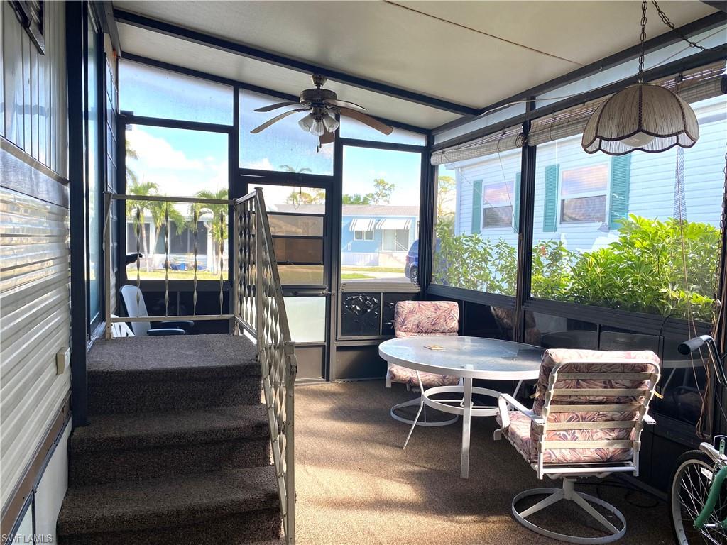 4561 Split Log Lane East Estero, FL 33928 - Photo 2 of 8 a living room with furniture and a floor to ceiling window