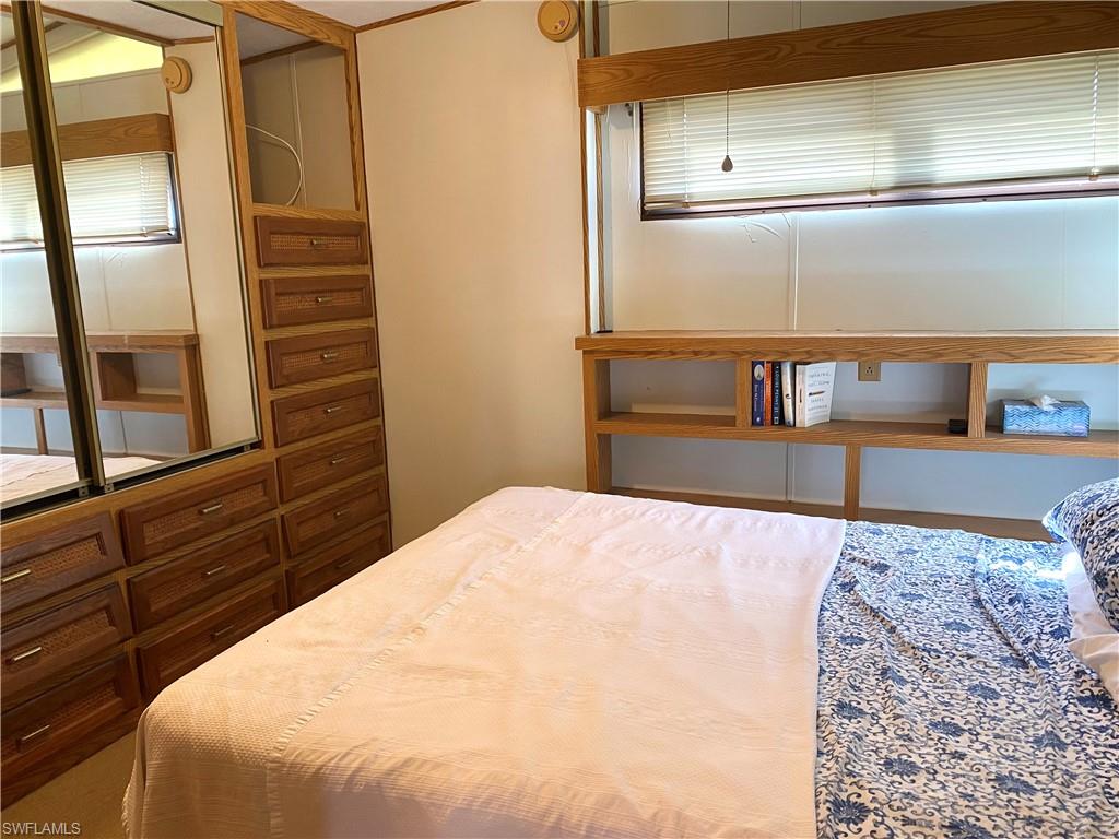 4561 Split Log Lane East Estero, FL 33928 - Photo 6 of 8 a bedroom with a bed and wooden floor