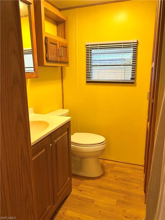 4561 Split Log Lane East Estero, FL 33928 - Photo 7 of 8 a bathroom with a toilet sink and a mirror