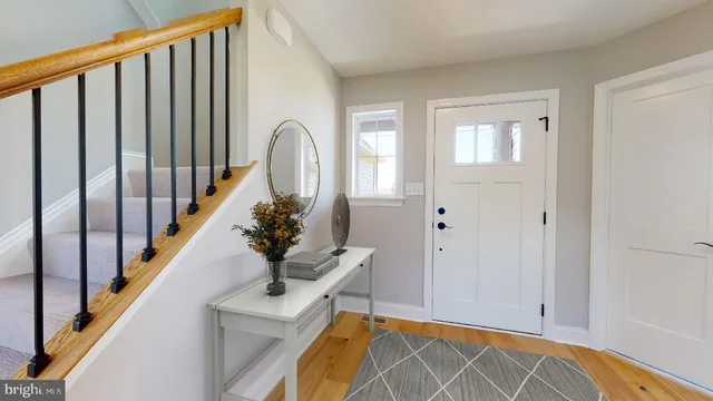 a view of an entryway with wooden floor