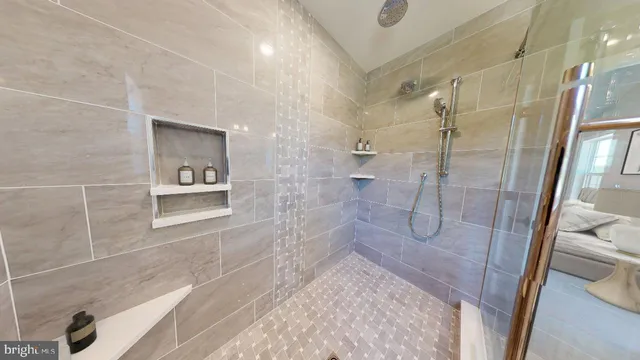 a bathroom with a shower and a sink