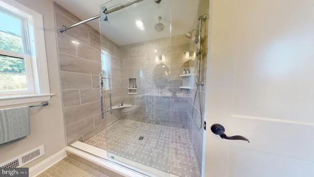 a bathroom with a glass shower door