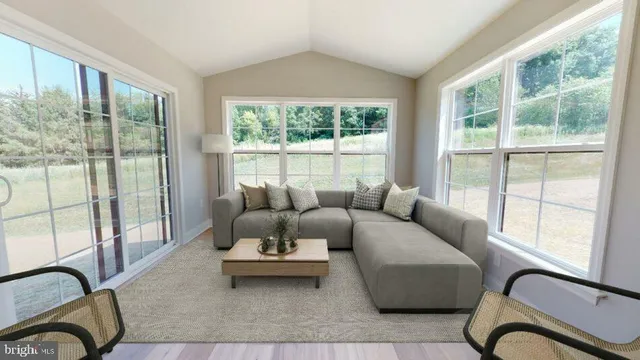 a living room with furniture and a floor to ceiling window
