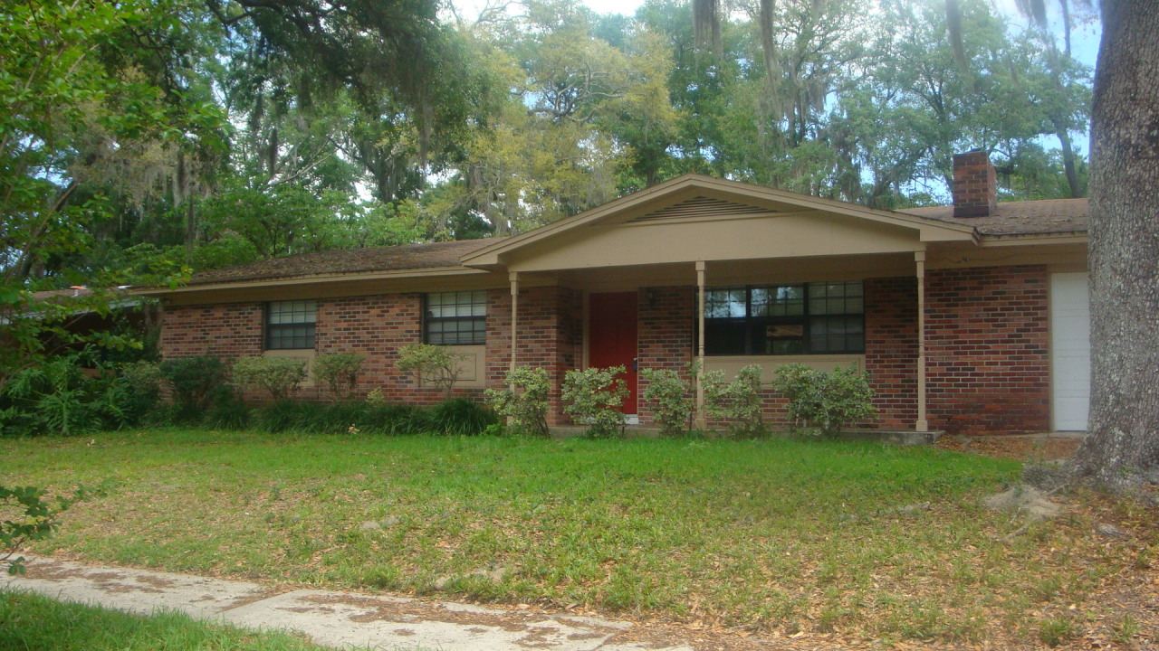3941 Bess Road Jacksonville, FL 32277 - Photo 1 of 4 a front view of a house with garden
