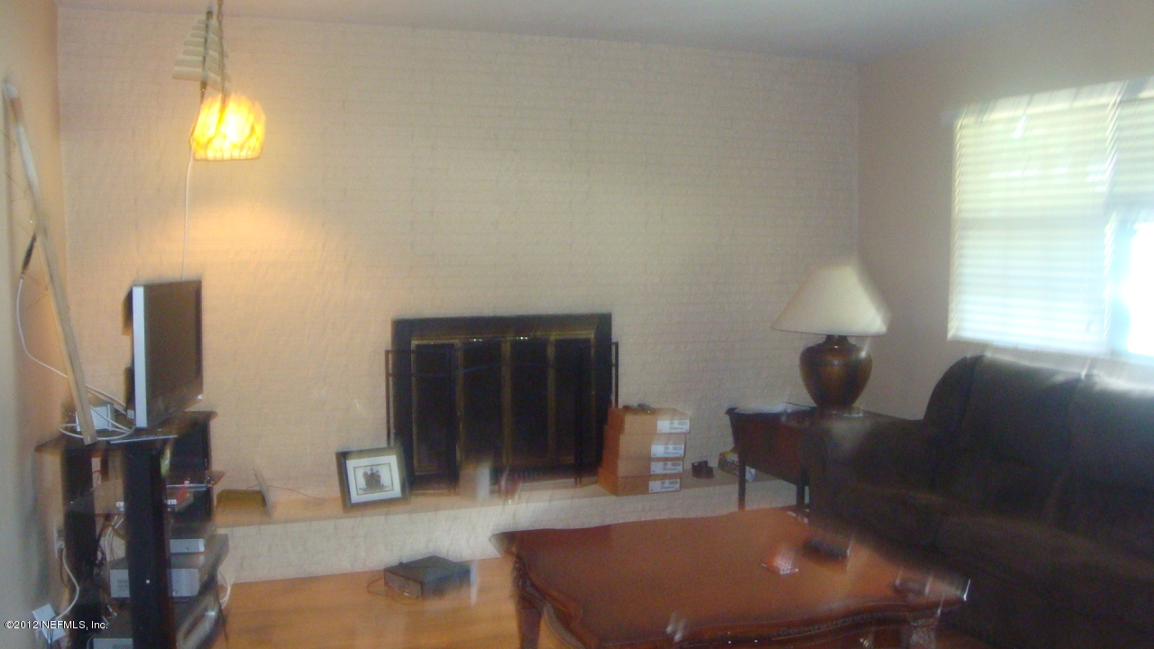 3941 Bess Road Jacksonville, FL 32277 - Photo 4 of 4 a living room with furniture and a flat screen tv