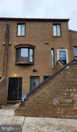 a front view of a house with a brick wall