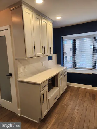 a kitchen with a sink a stove and a refrigerator