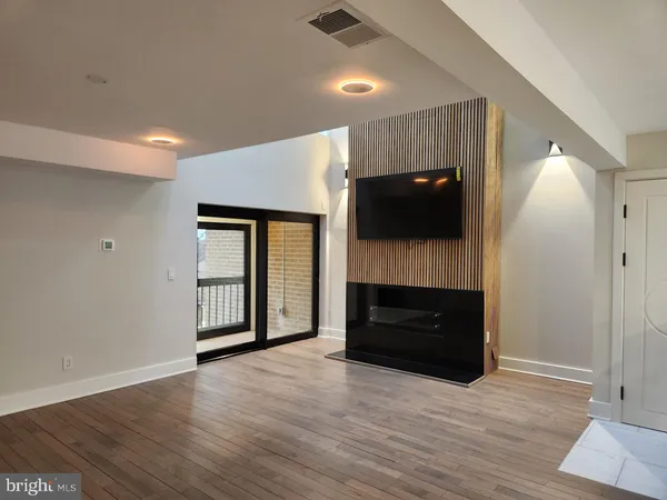wooden floor in an empty room with a fireplace