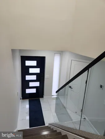 a view of staircase with white walls and railing