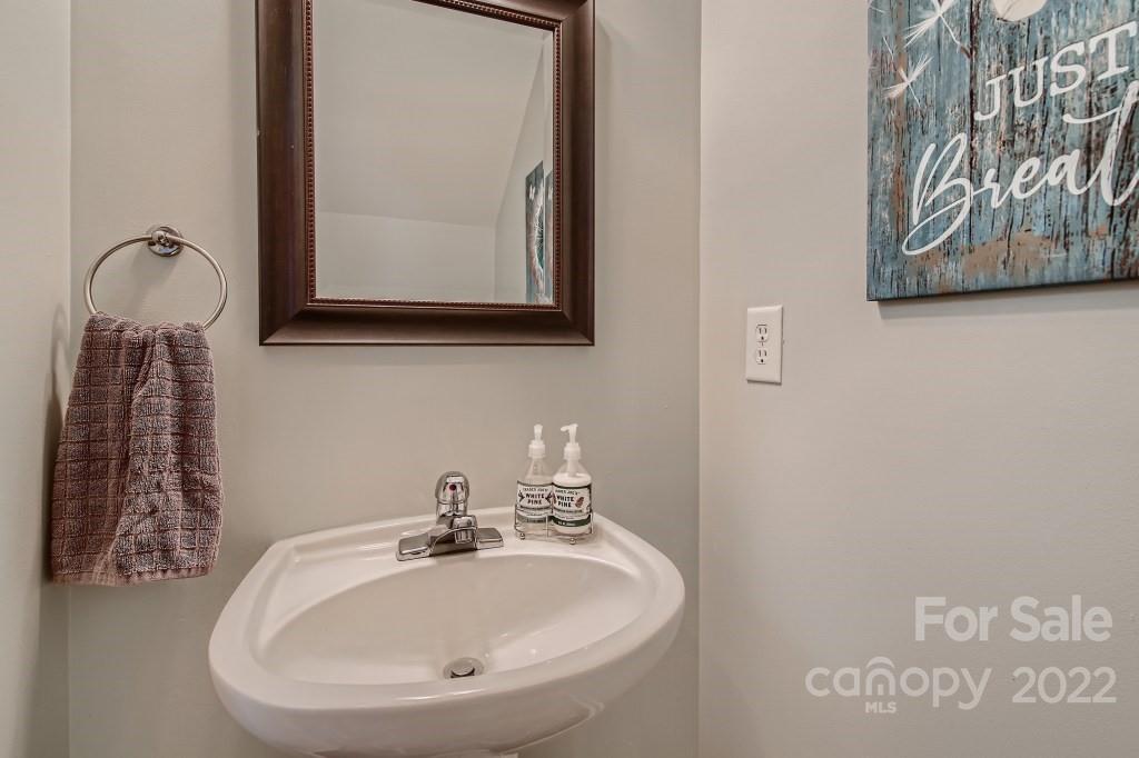 10461 Rocky Ford Club Road Charlotte, NC 28078 - Photo 13 of 27 a bathroom with a sink and a mirror