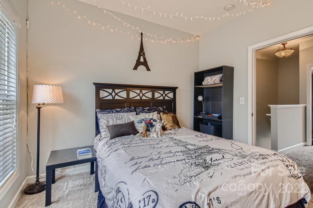 10461 Rocky Ford Club Road Charlotte, NC 28078 - Photo 15 of 27 a bedroom with a bed and a mirror
