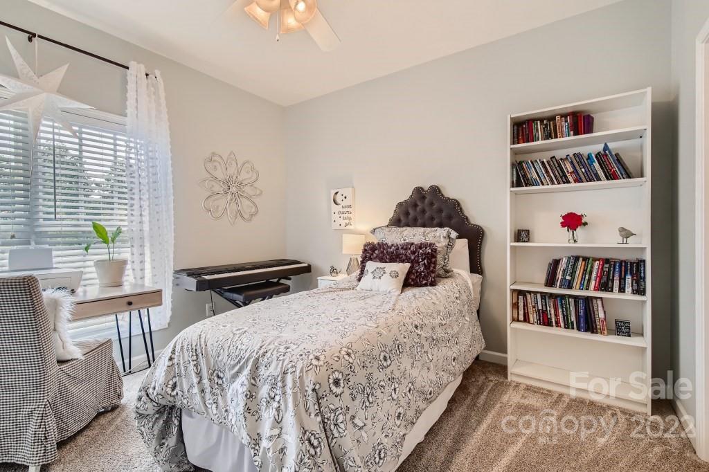 10461 Rocky Ford Club Road Charlotte, NC 28078 - Photo 19 of 27 a bedroom with a bed and a book shelf