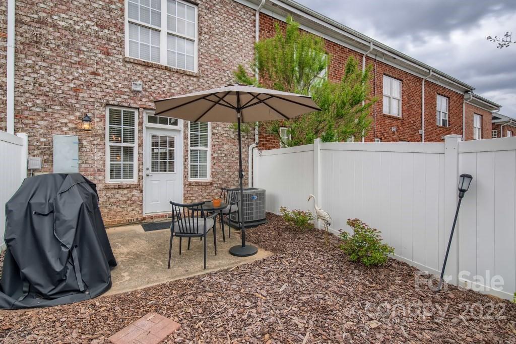 10461 Rocky Ford Club Road Charlotte, NC 28078 - Photo 25 of 27 a backyard of a house with barbeque oven table and chairs