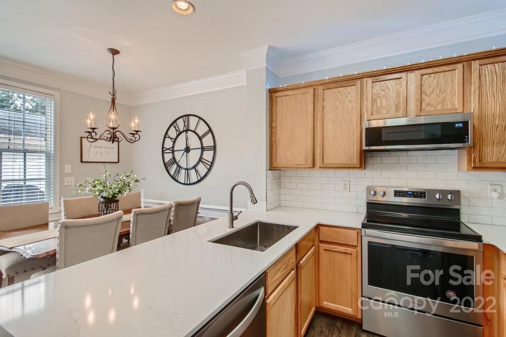 10461 Rocky Ford Club Road Charlotte, NC 28078 - Photo 9 of 27 a kitchen with a stove a sink and a microwave
