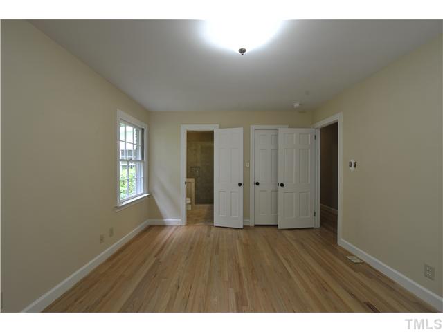 5010 Picardy Place Raleigh, NC 27612 - Photo 8 of 25 a view of an empty room with wooden floor and a window