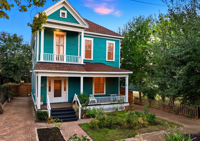 a front view of a house with garden