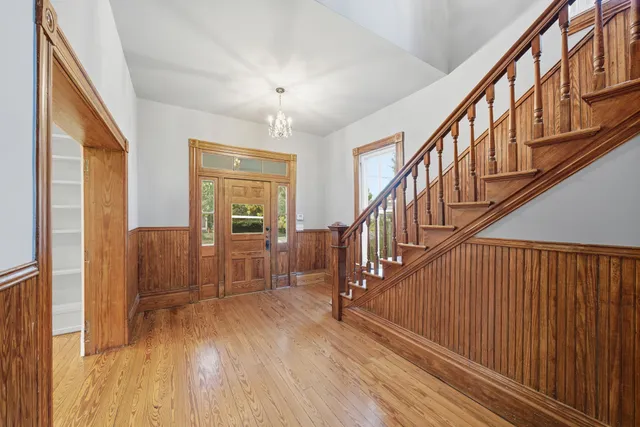 a view of staircase with wooden floor and fan