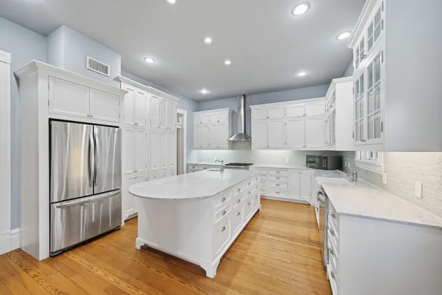 a large white kitchen with a large window
