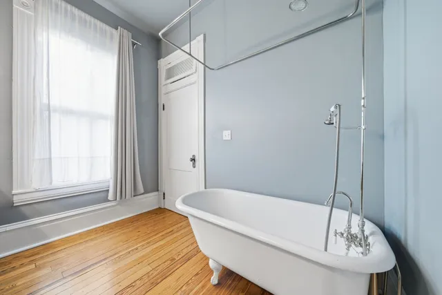a bathroom with a tub and shower