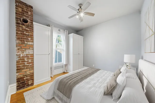 a bedroom with a large bed and a chandelier