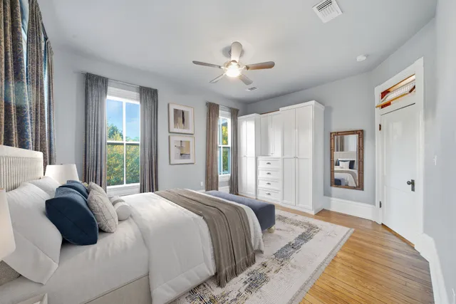a bedroom with a large bed and a chandelier